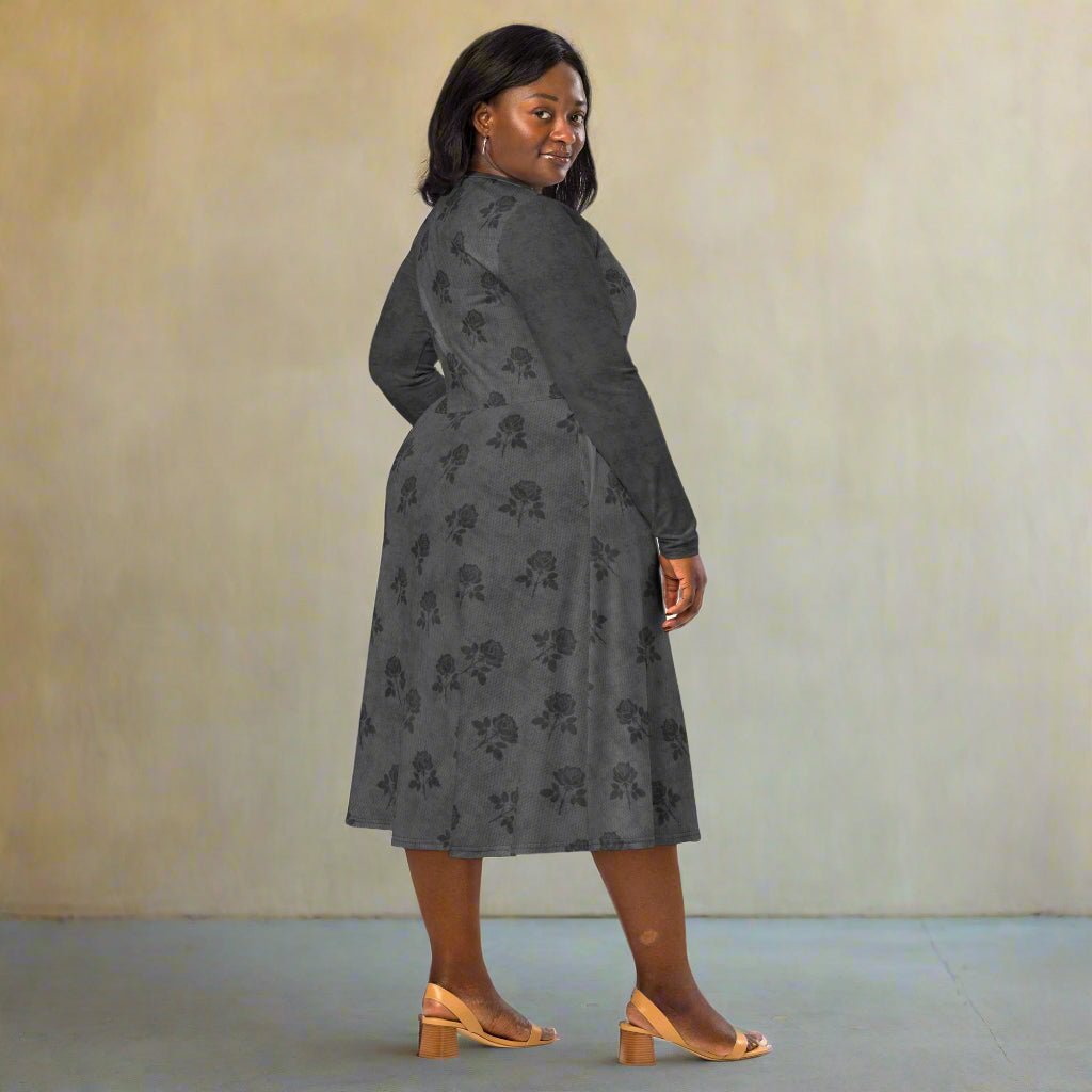 Woman wearing a gray floral dress against a plain background