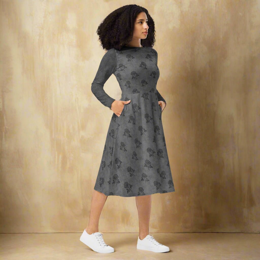 Woman wearing a gray dress with gray floral pattern on a neutral background