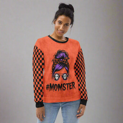 Person wearing an orange sweatshirt with a '#Momster' design on a white background