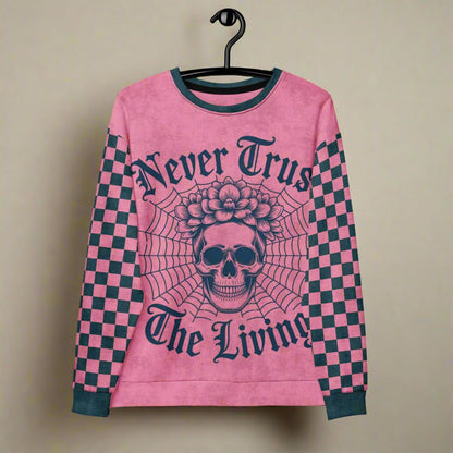 Pink sweater with skull design and text on a hanger