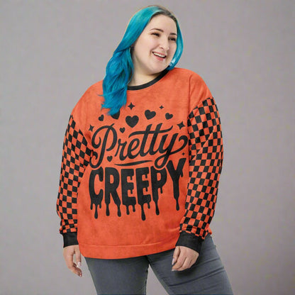 Person wearing an orange and black 'Pretty Creepy' sweatshirt with checkered pattern.