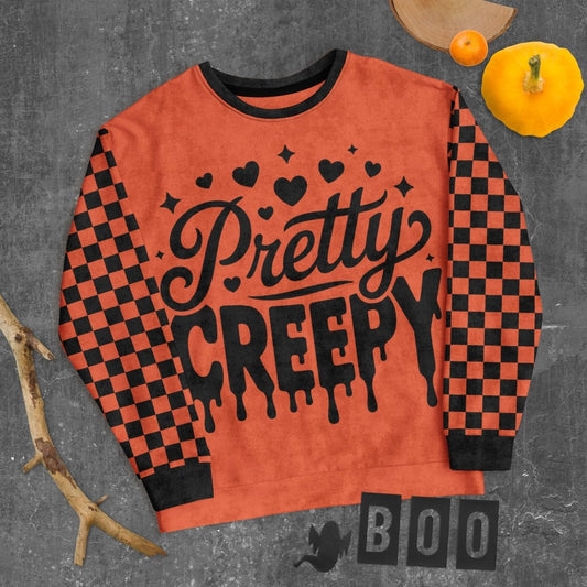Orange sweatshirt with 'Pretty Creepy' text on a gray background