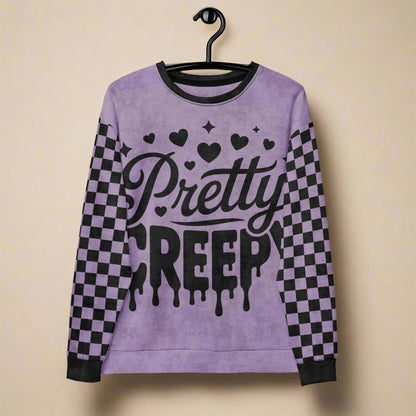 Purple sweatshirt with 'Pretty Creepy' text and checkered sleeves on a hanger