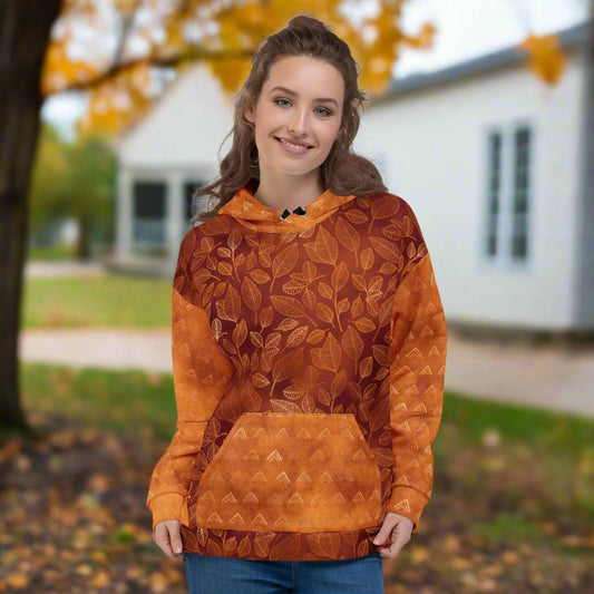 Person wearing an orange patterned hoodie outdoors with trees and a house in the background