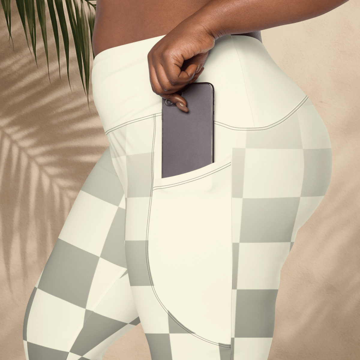 Person wearing a checkered leggings with pockets with a neutral background