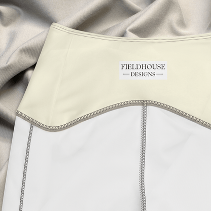 Close-up of a garment with 'Fieldhouse Designs' label, featuring beige and white colors.