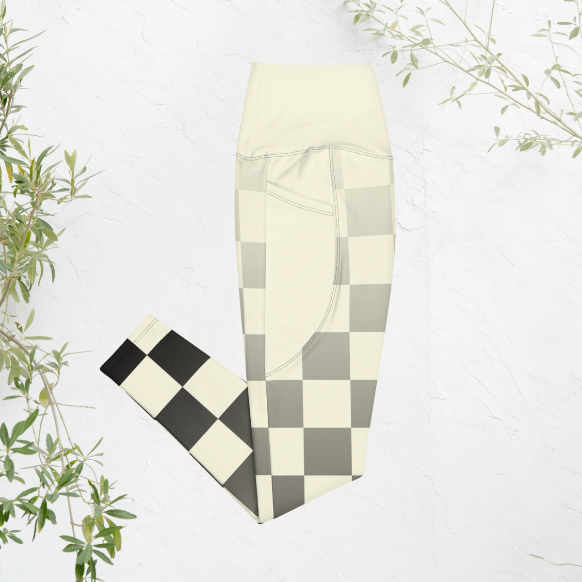 Checkered leggings with a pattern of black, white, and gray on a light background.