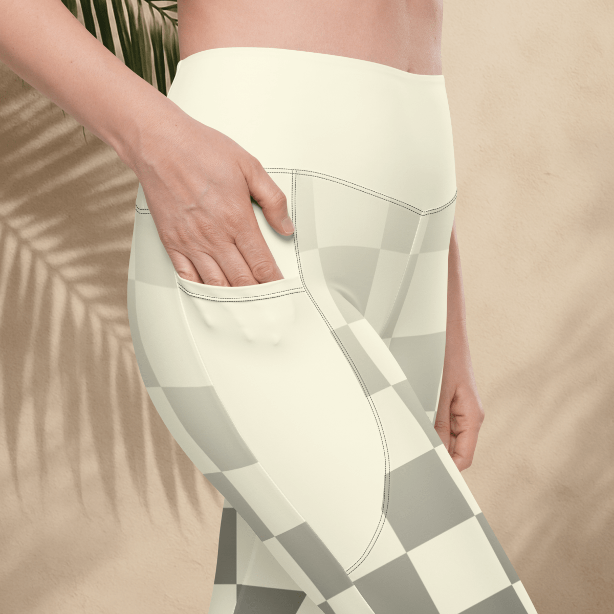 Person wearing a white and gray checkered pattern leggings with a blurred background
