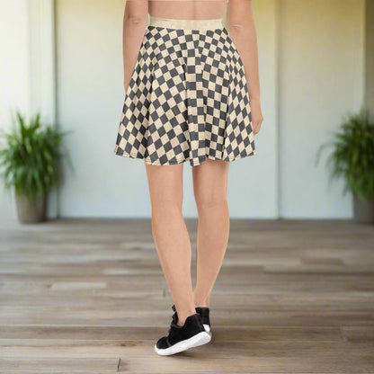 Person wearing a gray and ivory checkered skirt on a wooden floor.