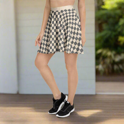 Person wearing a checkered skirt and black sneakers on a white background