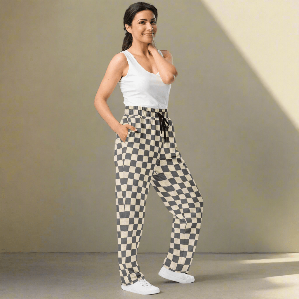 Woman wearing checkered pants on a neutral background