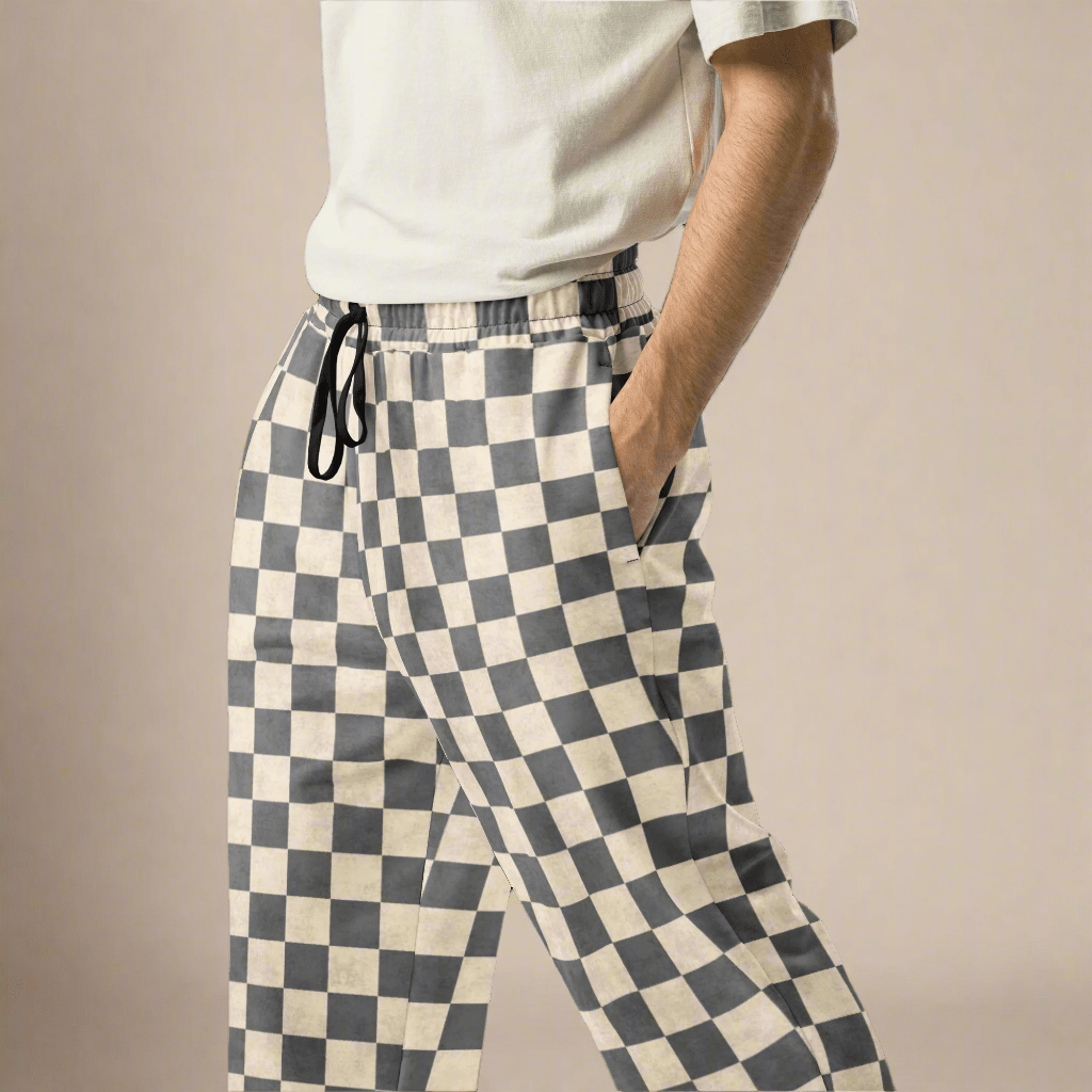 Person wearing checkered pants on a beige background