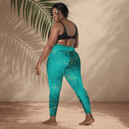 Woman wearing teal leggings with a subtle pattern, standing against a beige wall.