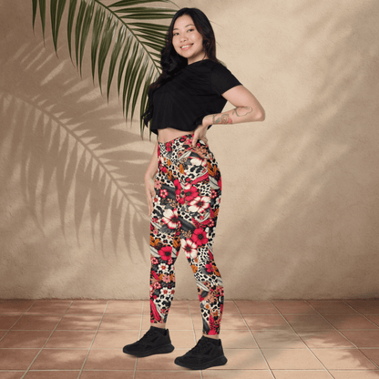 Woman wearing colorful patterned leggings and a black crop top against a beige wall.