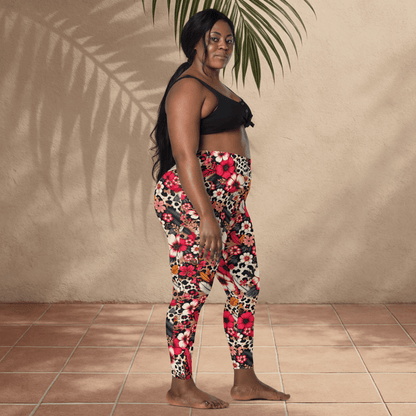 Woman wearing colorful floral leggings and a black top against a beige wall.