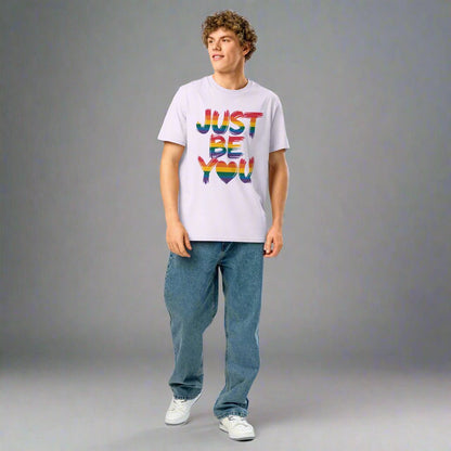 Person wearing a lavender t-shirt with 'JUST BE YOU' text in colorful letters on a white background