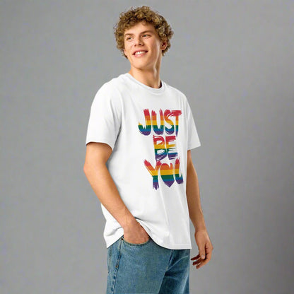 Person wearing a white t-shirt with 'JUST BE YOU' in rainbow letters on a white background