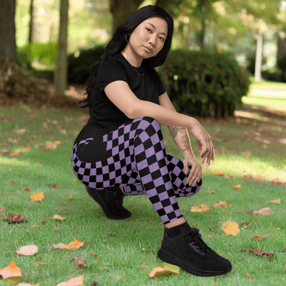 Person wearing black t-shirt and purple checkered pants outdoors