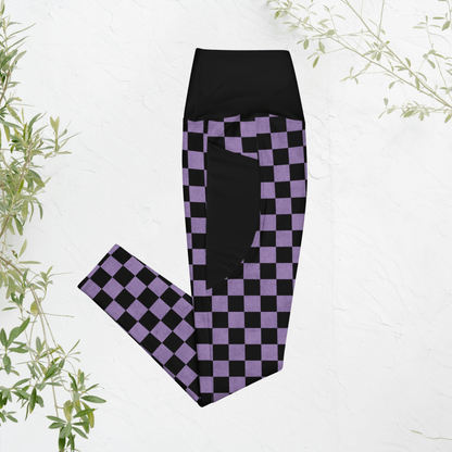 Black and purple checkered leggings on a white background with green leaves.