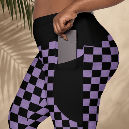 Person wearing black and purple checkered leggings with a pocket holding a phone.