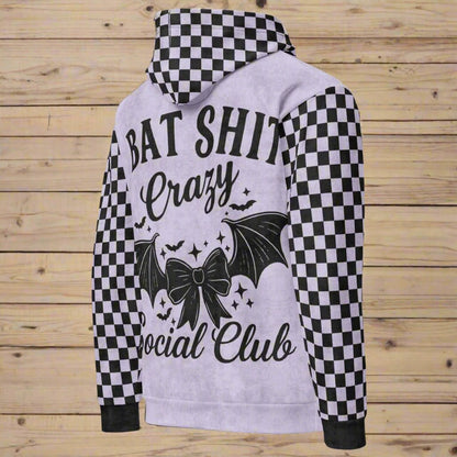 Hoodie with checkered sleeves and graphic design on a wooden background