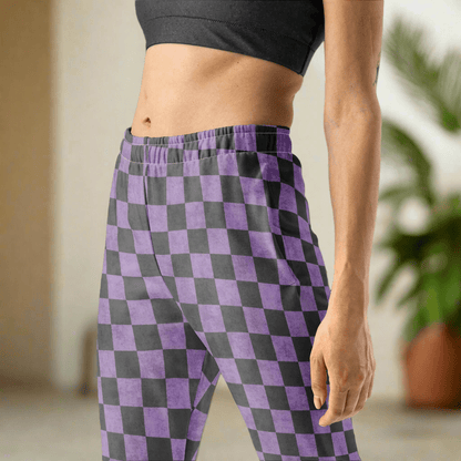 Person wearing purple and gray checkered pants with a blurred background