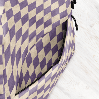 Purple and beige checkered bag on a light wooden surface