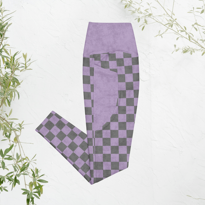 Purple and gray checkered leggings on a white background with green leaves.