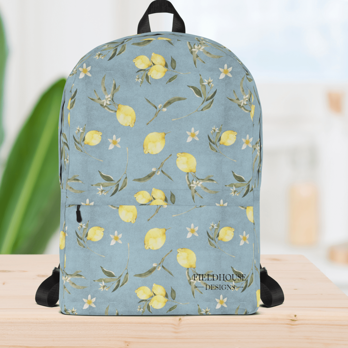 Backpack with lemon and floral pattern on a light blue background