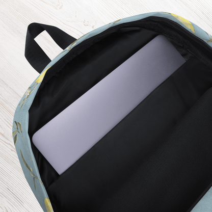 Backpack with a laptop inside on a light wooden surface