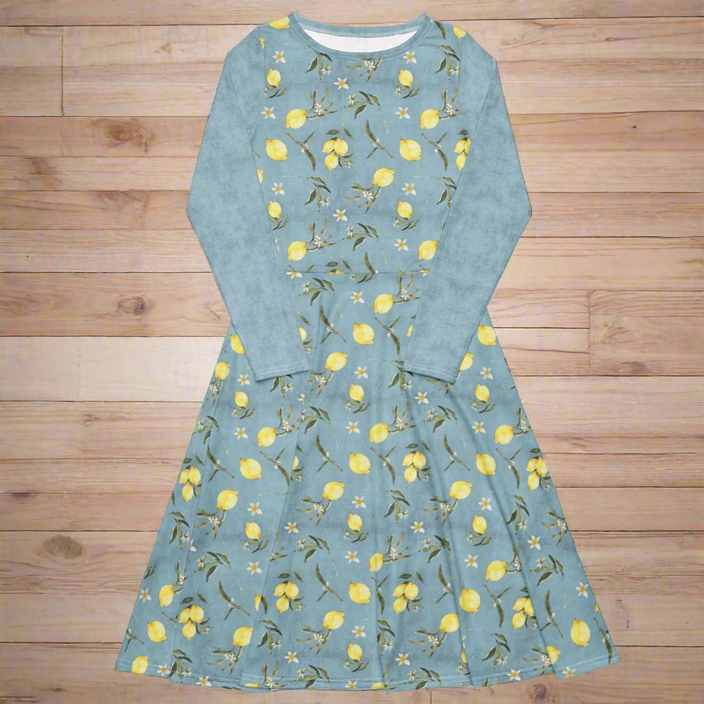 Blue dress with lemon pattern on a wooden surface