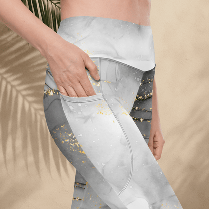 Gray leggings with gold speckles worn by a person against a beige background