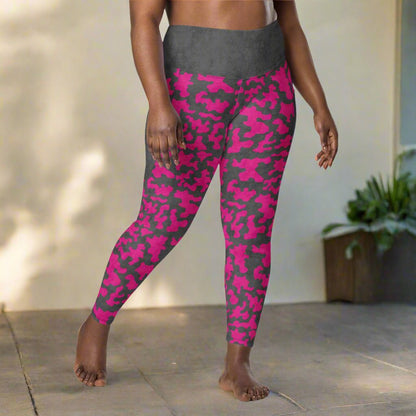 Person wearing pink and gray camouflage leggings outdoors.