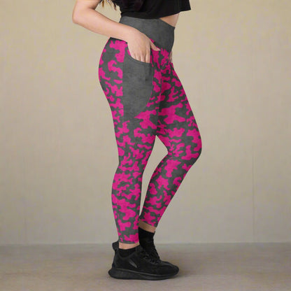 Person wearing pink and gray camouflage leggings on a neutral background