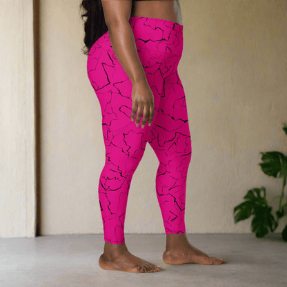 Person wearing bright pink leggings with black abstract pattern in a minimal indoor setting.