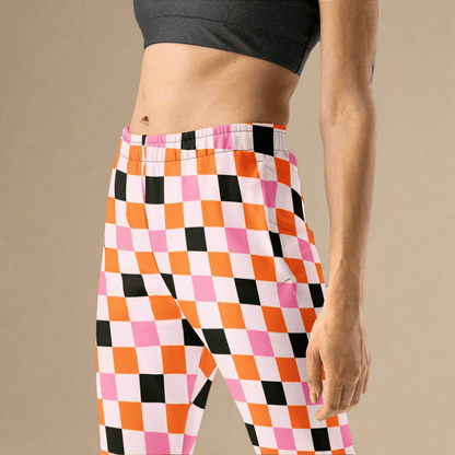 Person wearing colorful checkered pants on a beige background