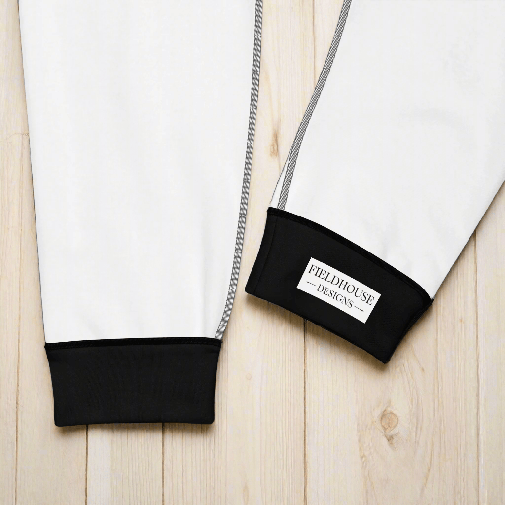 Close-up of black cuffs and a visible brand label on a white background