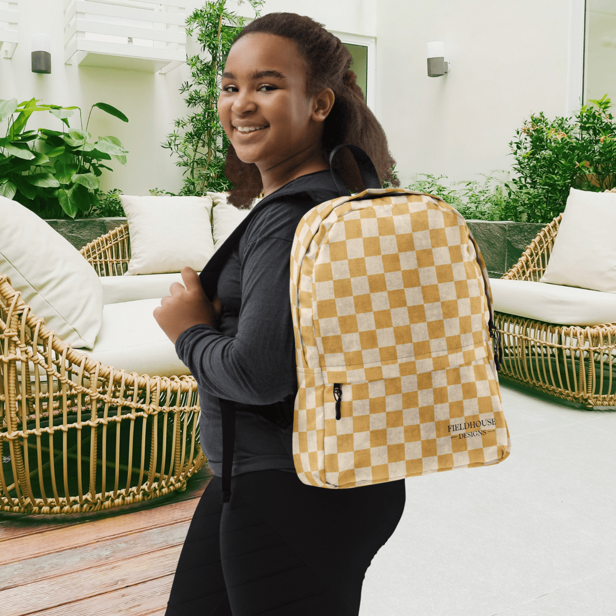 Person wearing a checkered backpack outdoors on a patio
