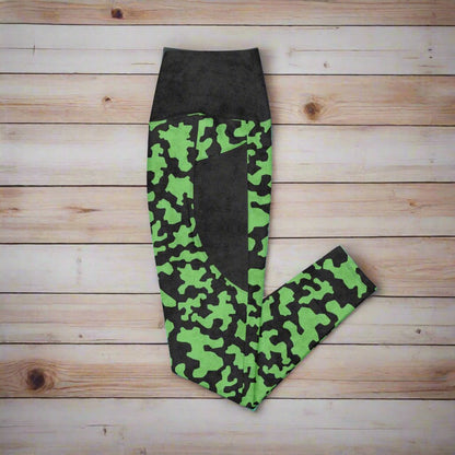 Green and black camouflage leggings on a wood background