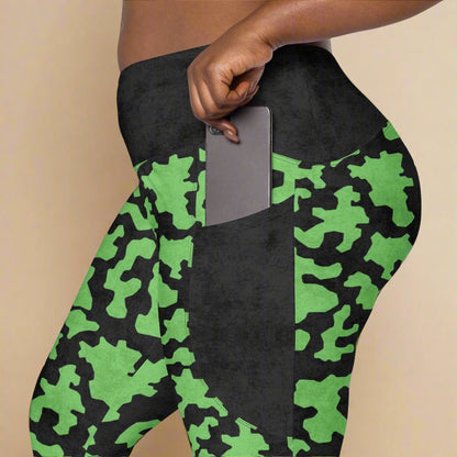 Green and black camouflage leggings with a pocket on a beige background