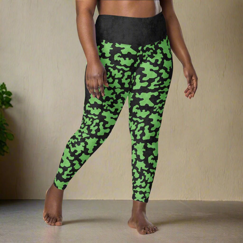 Green camouflage leggings worn by a person on a neutral background