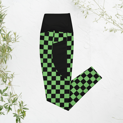 Green and black checkered leggings on a white background with plant decorations.