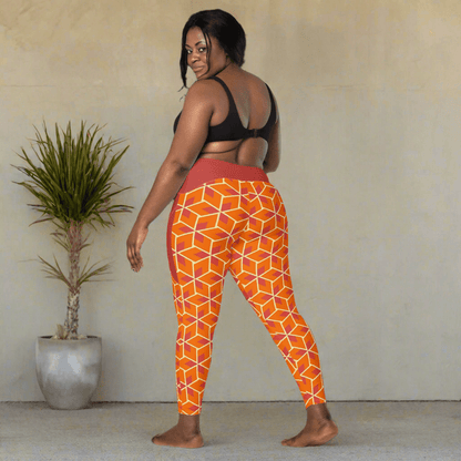 Woman wearing orange geometric patterned leggings on a neutral background