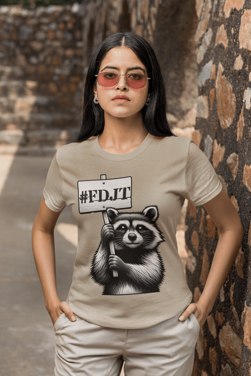 Person wearing a beige t-shirt with a raccoon graphic and '#FDJT' text.