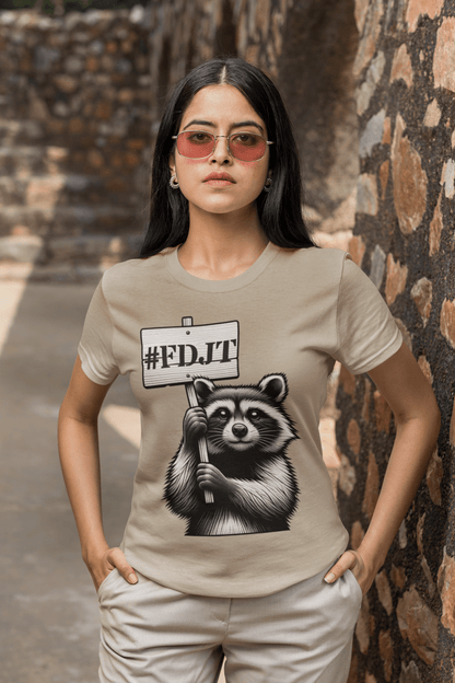 Person wearing a beige t-shirt with a raccoon graphic and '#FDJT' text.
