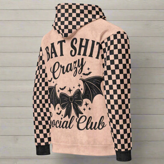 Hoodie with checkered sleeves and graphic design on a wooden background