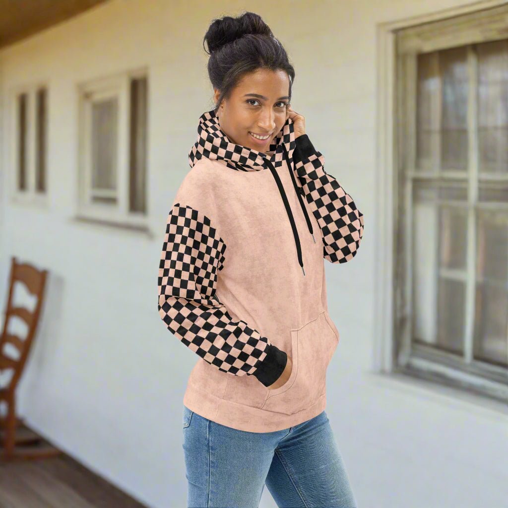 Woman wearing a peach and black checkered hoodie 