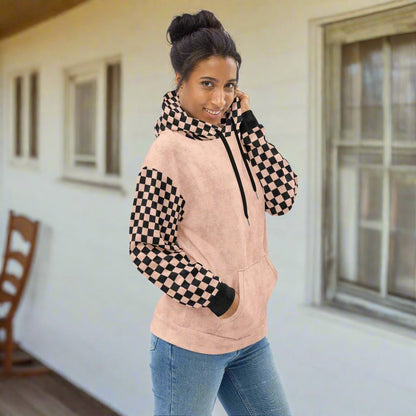 Woman wearing a peach and black checkered hoodie 