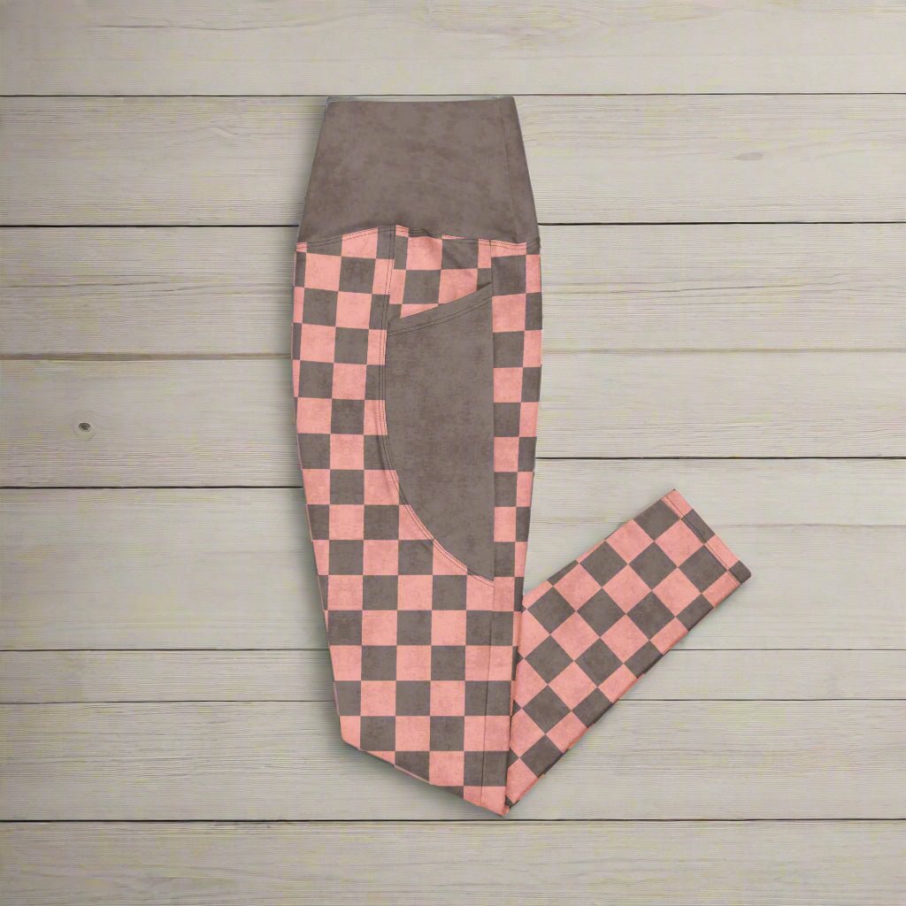 Checkered pants with pink and brown pattern on a wood background