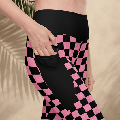 Person wearing black and pink checkered pants with a beige background